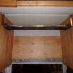 Dry fitting the bracket. Six bolts per side were run through the cabinet sides.